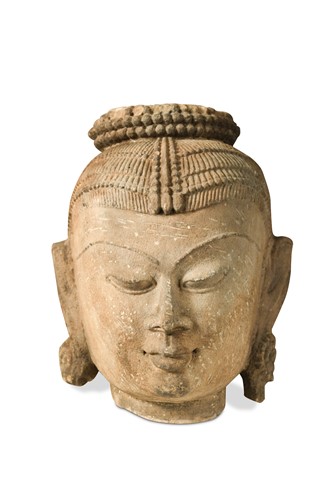 Lot 177 - An Indian carved sandstone head of a dancer, early 20th century