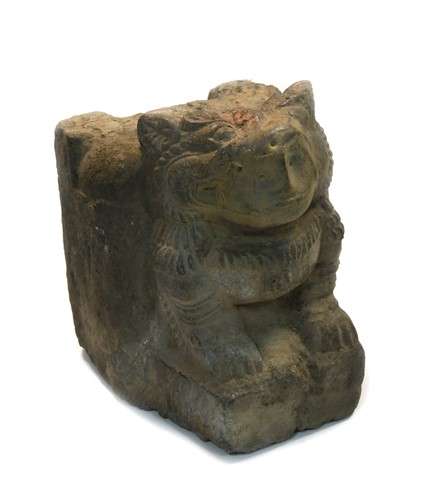 Lot 315 - A Nepal (Kathmandu Valley) carved stone crouched figure of a snow lion, 18th/19th century