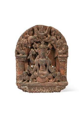 Lot 309 - A Nepal (Newar Culture) carved and painted wood fragmentary deity in an arch, 18th century or earlier