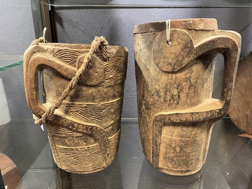 Lot 296 - Two Nepal, Mustang, carved wood milk jugs, 19th century