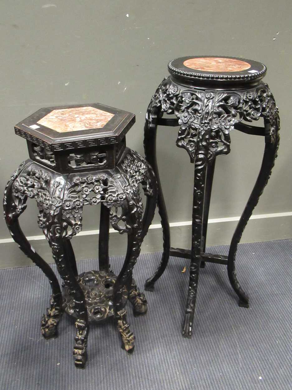 Lot 499 - Two marble inset Chinese hardwood urn stands,...