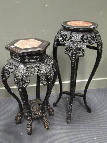 Lot 499 - Two marble inset Chinese hardwood urn stands,...