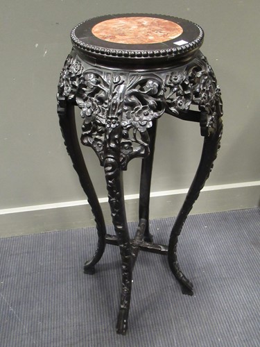 Lot 499 - Two marble inset Chinese hardwood urn stands,...