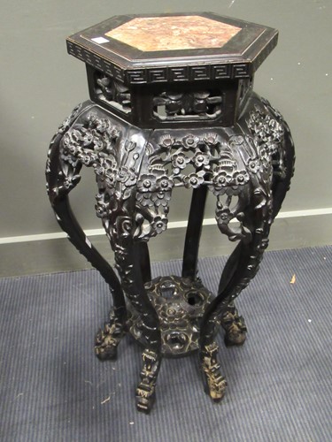 Lot 499 - Two marble inset Chinese hardwood urn stands,...