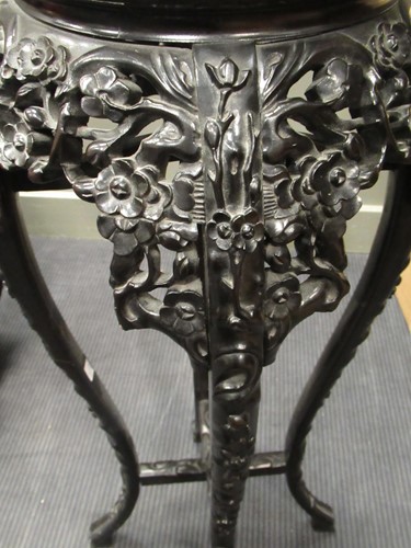 Lot 499 - Two marble inset Chinese hardwood urn stands,...