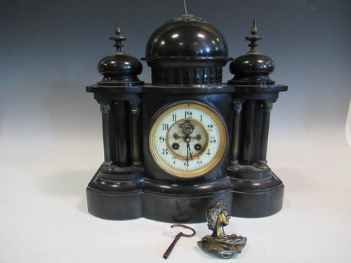 Lot 71 - A black slate mantle clock, the central finial...