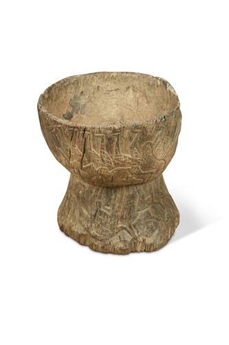 Lot 317 - A Southern Nepal (Terai Region) carved wood chopping board and mortar combined, 19th century
