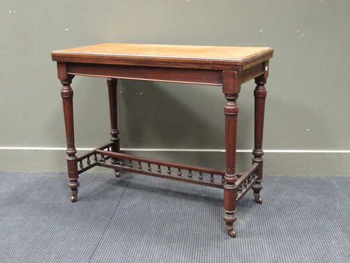 Lot 474 - A fold over games table, with tooled red...
