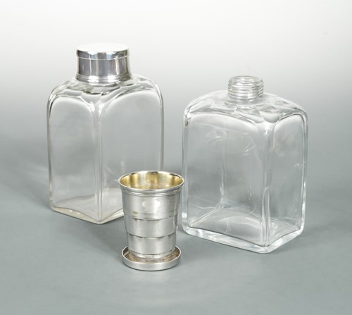 Lot 333 - A pair of glass spirit flasks with silver plated novelty caps