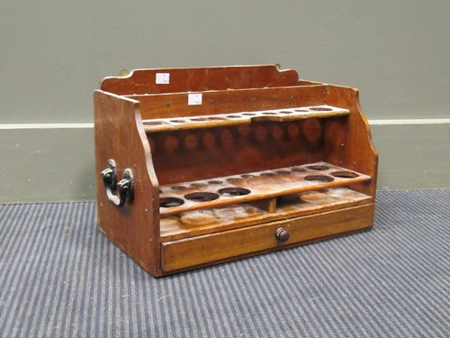 Lot 173 - A wooden pipe rack 40.5cm wide and a leather...