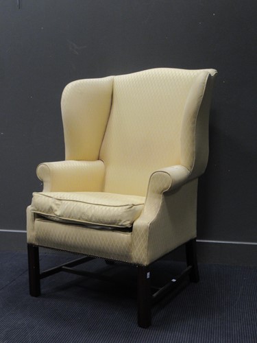 Lot 467 - A George III style wingback armchair, yellow...