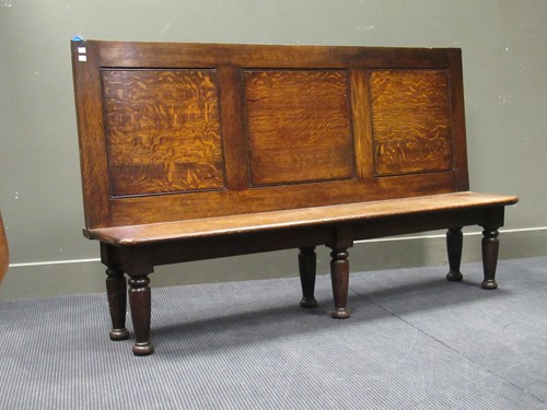 Lot 447 - An oak settle, with a three panelled back, on...