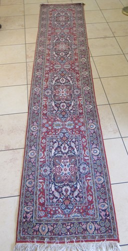 Lot 601 - A hand knotted North West Persian runner 394 x...