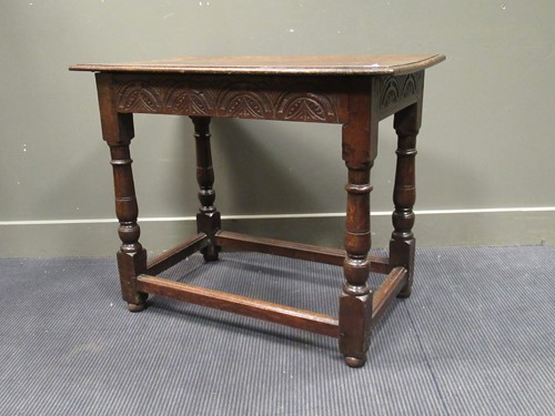 Lot 511 - An 18th century oak side table, the two plank...
