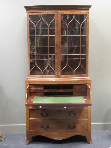 Lot 558 - A late George III bow fronted secretaire bookcase