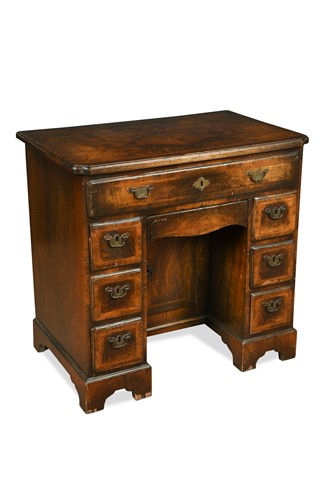Lot 249 - A George I walnut kneehole desk