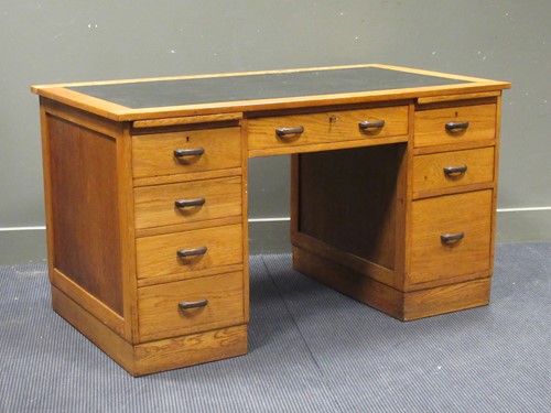Lot 542 - An Art Deco light oak twin pedestal desk of...