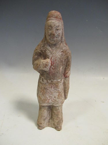 Lot 174 - A Tang dynasty pottery standing figure, he...