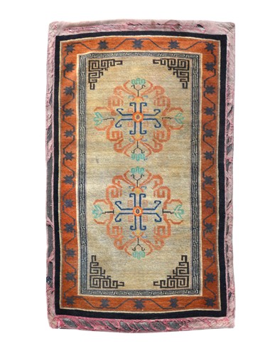 Lot 365 - A floral and geometric rug, perhaps Khotan (Chinese Turkistan), early 20th century
