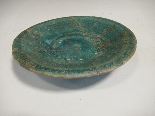 Lot 22 - A Kashan pottery green glazed dish, 15cm diameter