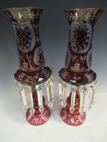 Lot 100 - A pair of red glass candle lustres, 45cm high