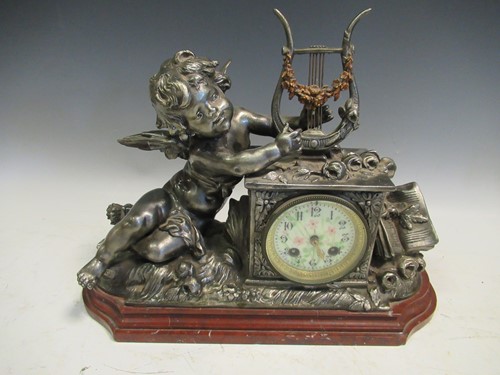 Lot 139 - A French metal mantle clock with a porcleain...