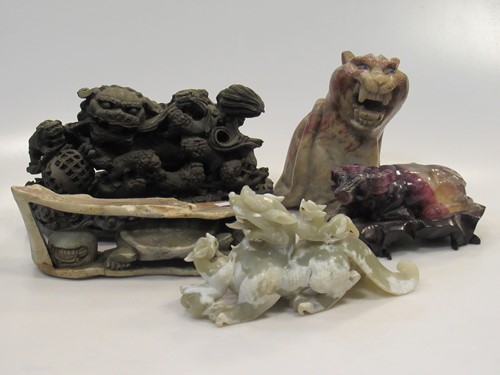 Lot 113 - A carved hardstone seated lion with inset blue...