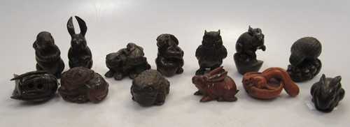 Lot 119 - Thirteen carved wood animal netsuke, including...