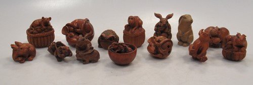 Lot 116 - Fourteen carved wood animal netsuke including...