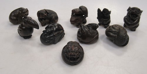 Lot 114 - Ten carved wood animal netsuke including dogs...