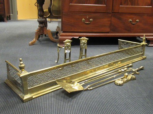 Lot 562 - A pierced brass fender; together with a pair...