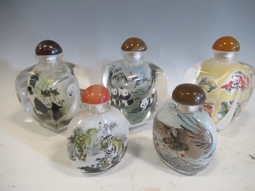 Lot 3 - Five modern glass snuff bottles, the interiors...