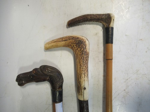 Lot 159 - Three walking sticks, one carved as a horse's...