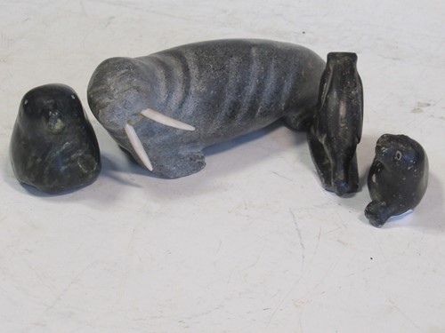 Lot 125 - A collection of four soapstone Inuit carvings,...