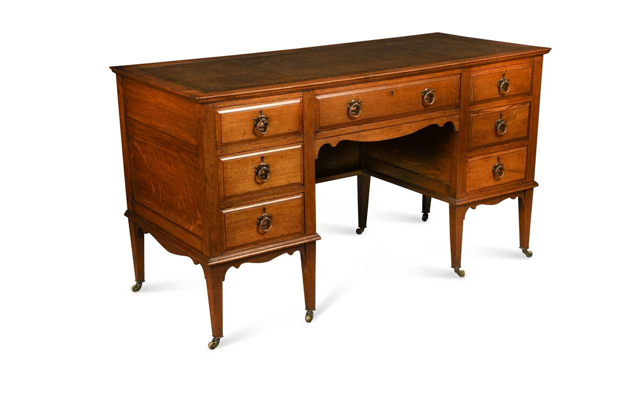 Lot 209 - An Arts & Crafts oak desk by James Shoolbred & Co.
