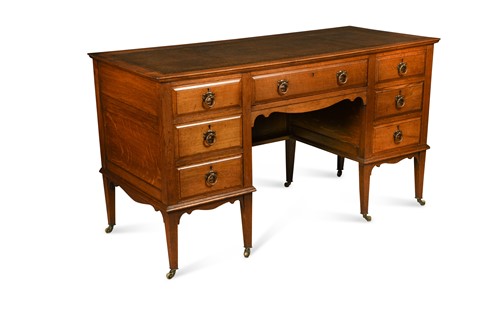 Lot 209 - An Arts & Crafts oak desk by James Shoolbred & Co.