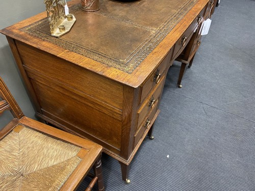 Lot 209 - An Arts & Crafts oak desk by James Shoolbred & Co.