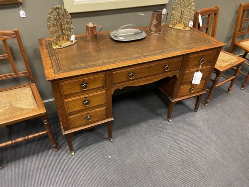 Lot 209 - An Arts & Crafts oak desk by James Shoolbred & Co.