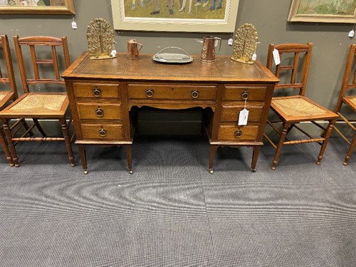 Lot 209 - An Arts & Crafts oak desk by James Shoolbred & Co.