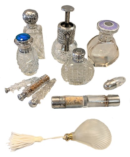Lot 307 - An Edward VII silver topped glass atomiser and a collection of clear glass scent bottles