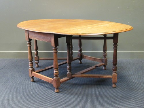 Lot 376 - An large Victorian oak drop leaf dining table...