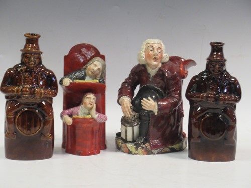 Lot 77 - Two treacle glazed spirit flasks modelled as...