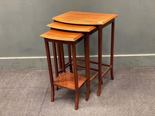 Lot 492 - A nest of three bow fronted mahogany tables,...