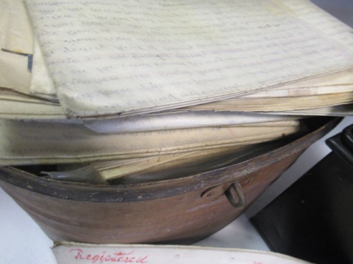 Lot 93 - A desk top writing slope, an oval tin hat box...