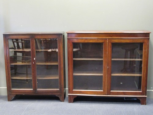 Lot 489 - An early 20th century oak bookcase with a pair...