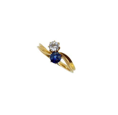 Lot 12 - A two stone sapphire and diamond crossover style ring