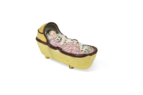 Lot 196 - A large Staffordshire pearlware cradle with a sleeping child, circa 1800
