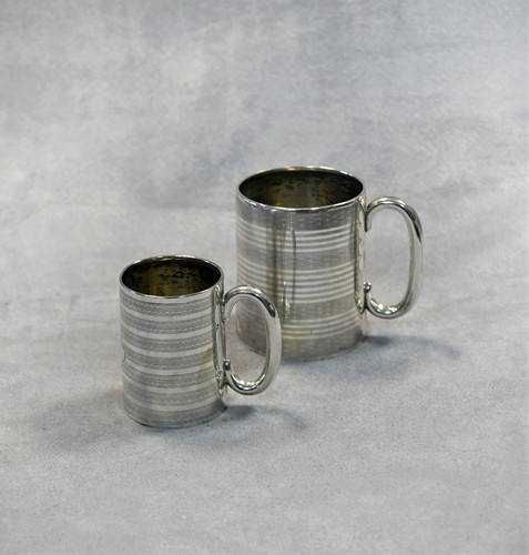 Lot 453 - Two George V silver miniature tankards