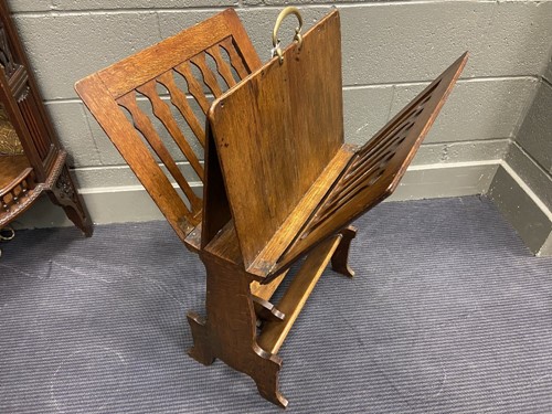 Lot 218 - Liberty & Co., an Arts & Crafts oak 'Caxton' magazine rack, circa 1904
