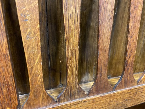 Lot 218 - Liberty & Co., an Arts & Crafts oak 'Caxton' magazine rack, circa 1904